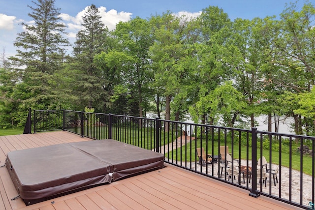 wooden terrace with a covered hot tub