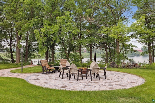 view of patio / terrace featuring a water view and a fire pit