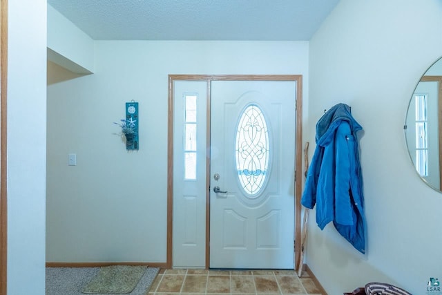 entrance foyer with a textured ceiling