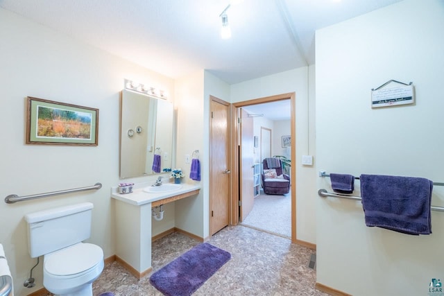 bathroom featuring sink and toilet