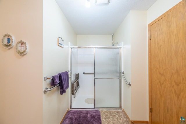 bathroom featuring a shower with door