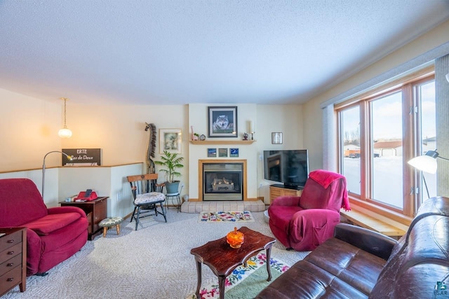 carpeted living room with a tiled fireplace and a textured ceiling