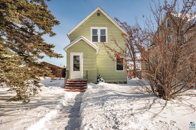 view of snow covered rear of property