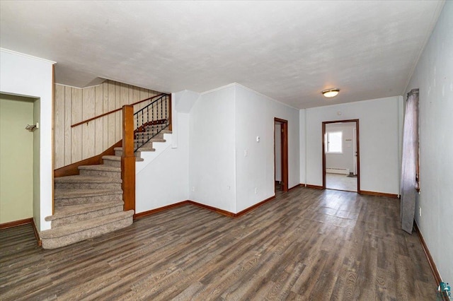 interior space with crown molding, a baseboard radiator, and dark hardwood / wood-style floors