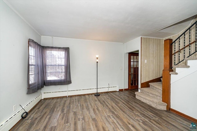 empty room featuring crown molding, dark hardwood / wood-style flooring, and a baseboard heating unit