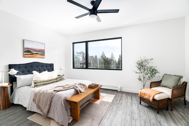 bedroom featuring a baseboard radiator, hardwood / wood-style floors, and ceiling fan