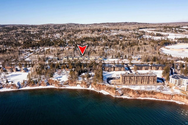 snowy aerial view featuring a water view