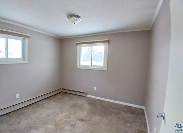 spare room featuring ornamental molding, a baseboard heating unit, and a wealth of natural light