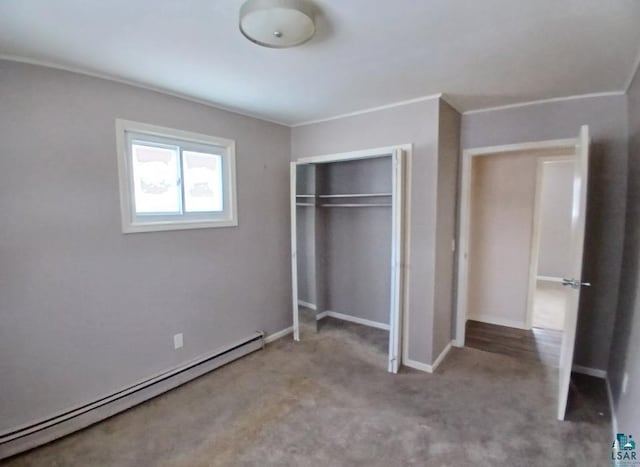 unfurnished bedroom featuring crown molding, light colored carpet, a closet, and a baseboard heating unit