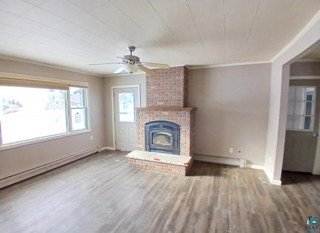 unfurnished living room featuring a baseboard heating unit, crown molding, wood-type flooring, and a fireplace