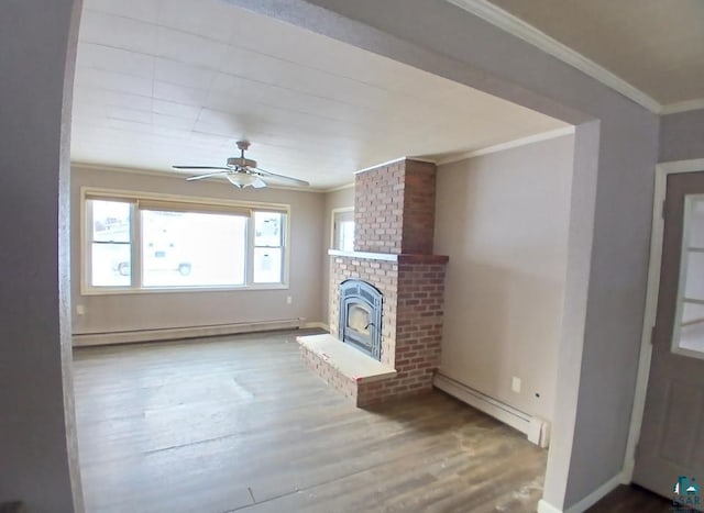 unfurnished living room with hardwood / wood-style flooring, a baseboard radiator, and ornamental molding