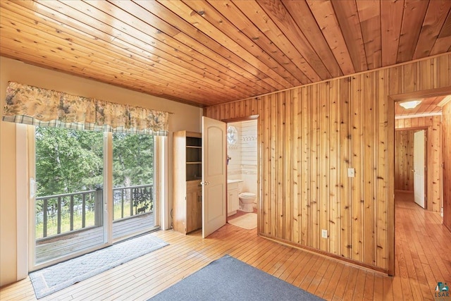 interior space with wooden walls, light hardwood / wood-style floors, and wooden ceiling