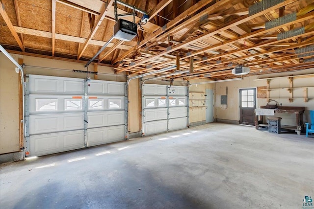 garage featuring a garage door opener and electric panel