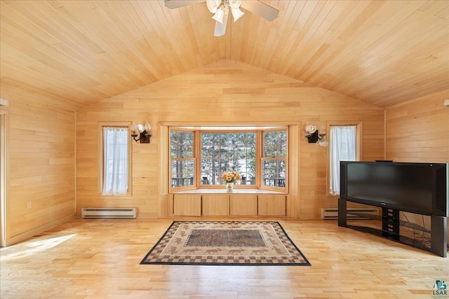 living room featuring vaulted ceiling, a healthy amount of sunlight, and wood walls