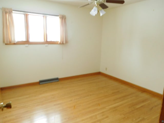 empty room featuring light wood-type flooring and ceiling fan