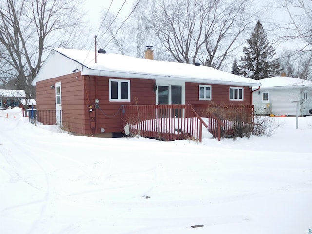 view of snow covered back of property