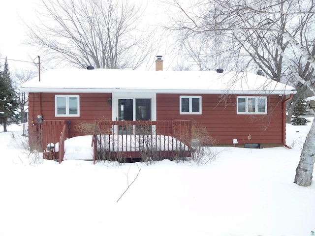 view of snow covered back of property