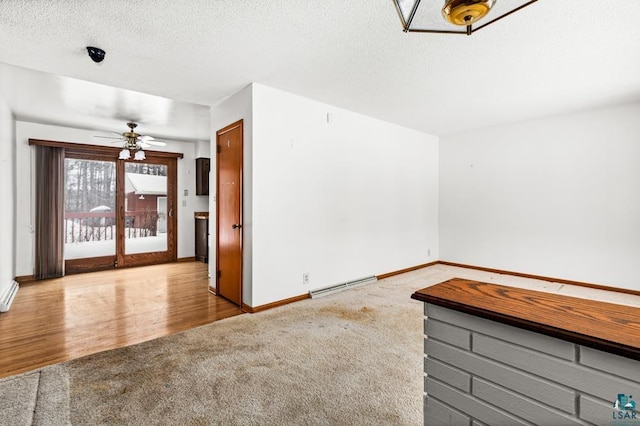 unfurnished room featuring ceiling fan, a textured ceiling, and light colored carpet