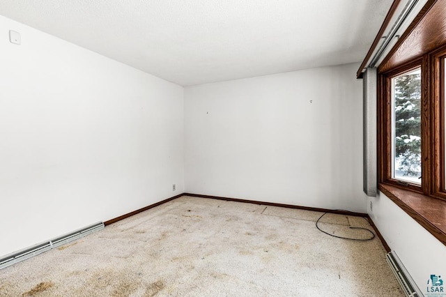 spare room with a baseboard radiator and light carpet