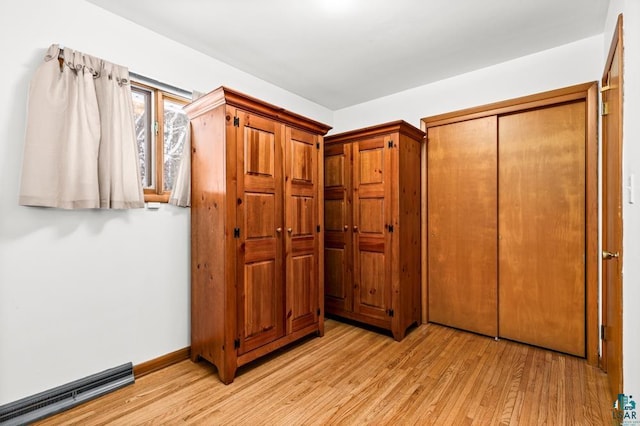 hallway with light hardwood / wood-style flooring