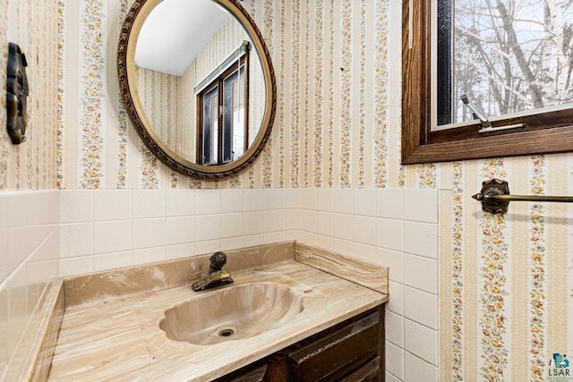 bathroom featuring tile walls and vanity