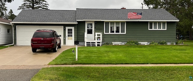 ranch-style home with a garage and a front yard