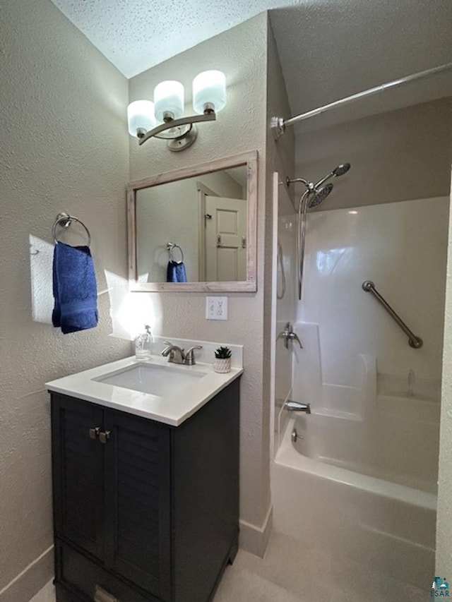 bathroom with vanity, shower / bathtub combination, and a textured ceiling