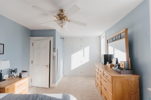 bedroom with ceiling fan and light colored carpet