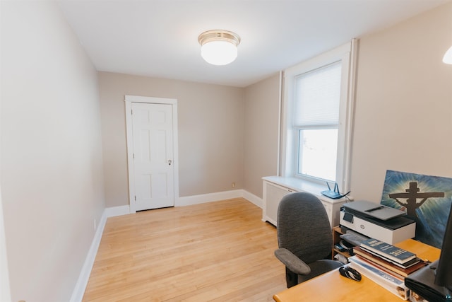 home office with light hardwood / wood-style floors