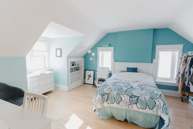 bedroom with light hardwood / wood-style flooring and vaulted ceiling