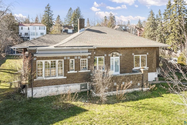 rear view of house with a yard