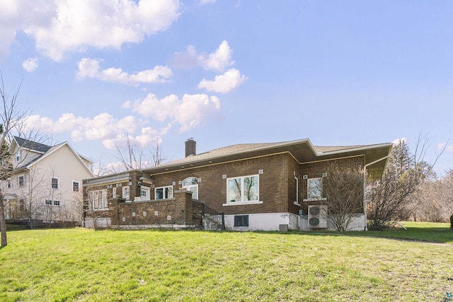 back of house with a lawn