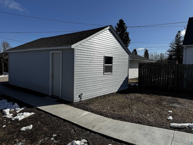view of outbuilding with an outdoor structure and fence