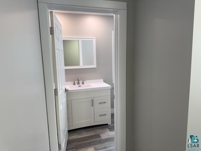 bathroom with vanity and hardwood / wood-style floors