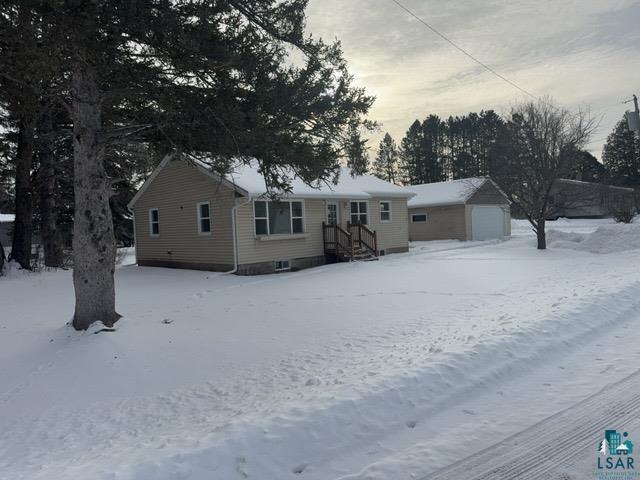 view of front of home with a garage and an outdoor structure