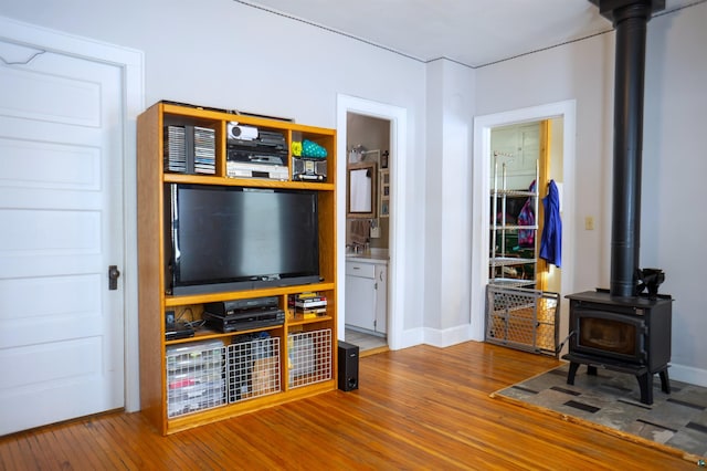 living room featuring hardwood / wood-style floors and a wood stove