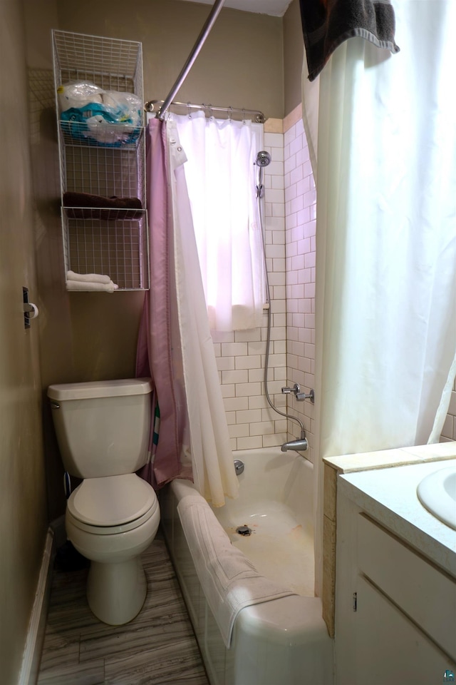 full bathroom with shower / tub combo with curtain, toilet, and vanity