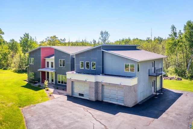 contemporary home with a garage, driveway, and a front lawn