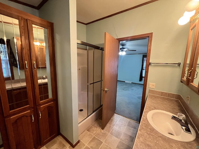 bathroom featuring a stall shower, a ceiling fan, crown molding, and vanity