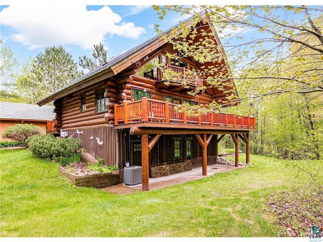 back of house with a patio area, a yard, log exterior, and central AC unit