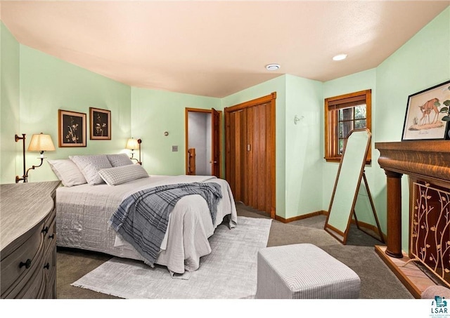 bedroom featuring carpet, baseboards, and a closet