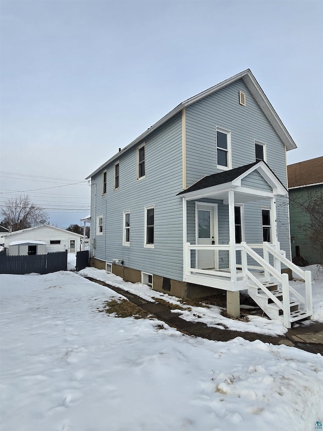 view of front of property featuring fence