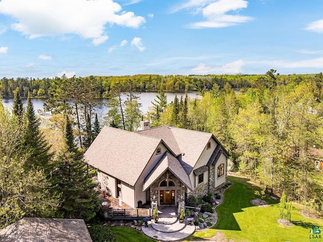 bird's eye view with a water view and a wooded view