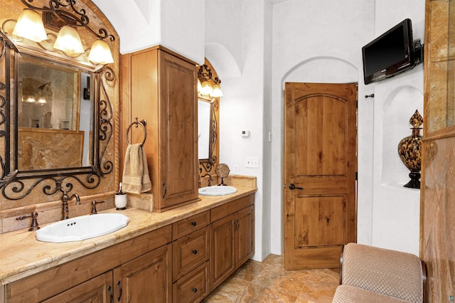 bathroom with a sink and double vanity