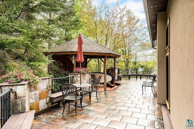 view of patio featuring a gazebo and fence