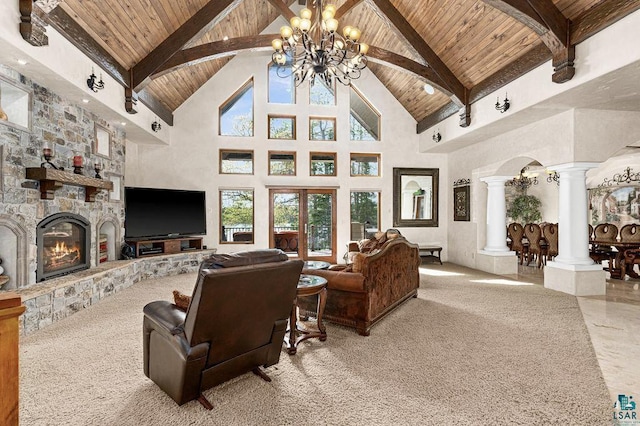 living room with a fireplace, wood ceiling, high vaulted ceiling, beamed ceiling, and ornate columns