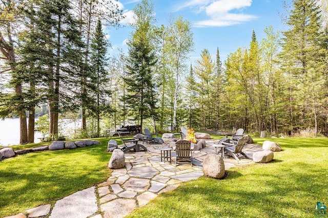 view of yard with an outdoor fire pit and a patio area