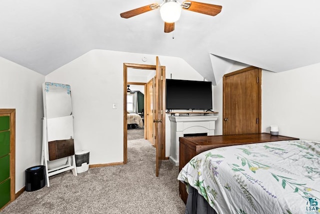 bedroom with carpet floors, baseboards, vaulted ceiling, and a ceiling fan