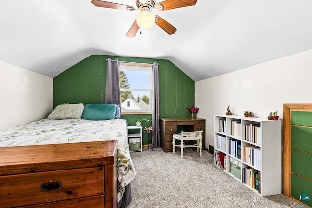 bedroom featuring a ceiling fan, vaulted ceiling, and carpet flooring