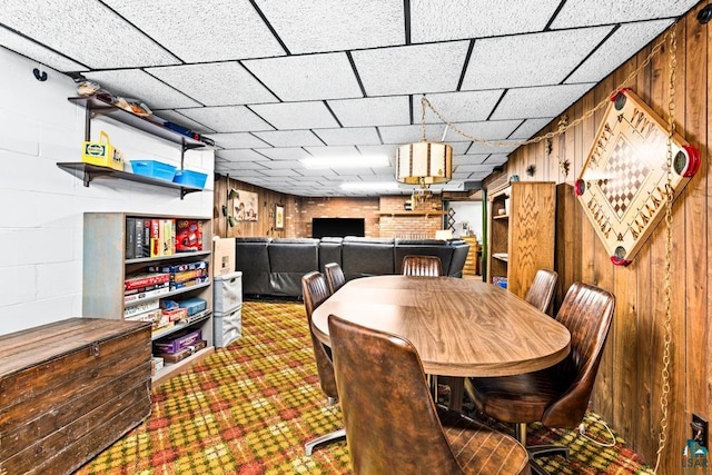 dining area with concrete block wall and wood walls